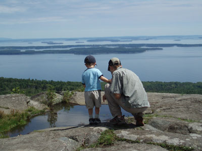 Checking out tadpoles atop the Maine coast.