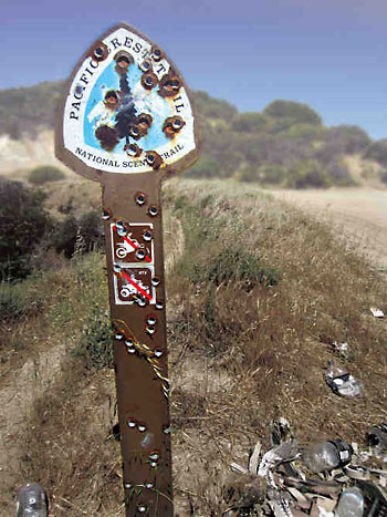 Shot-up PCT trail sign. Shot-up PCT trail sign.
