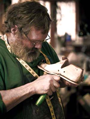 Peter Limmer adjusting a custom boot last.