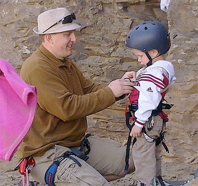 Jeff gearing up his 4 year old for his first rock climb, Frenchman Coulee, WA